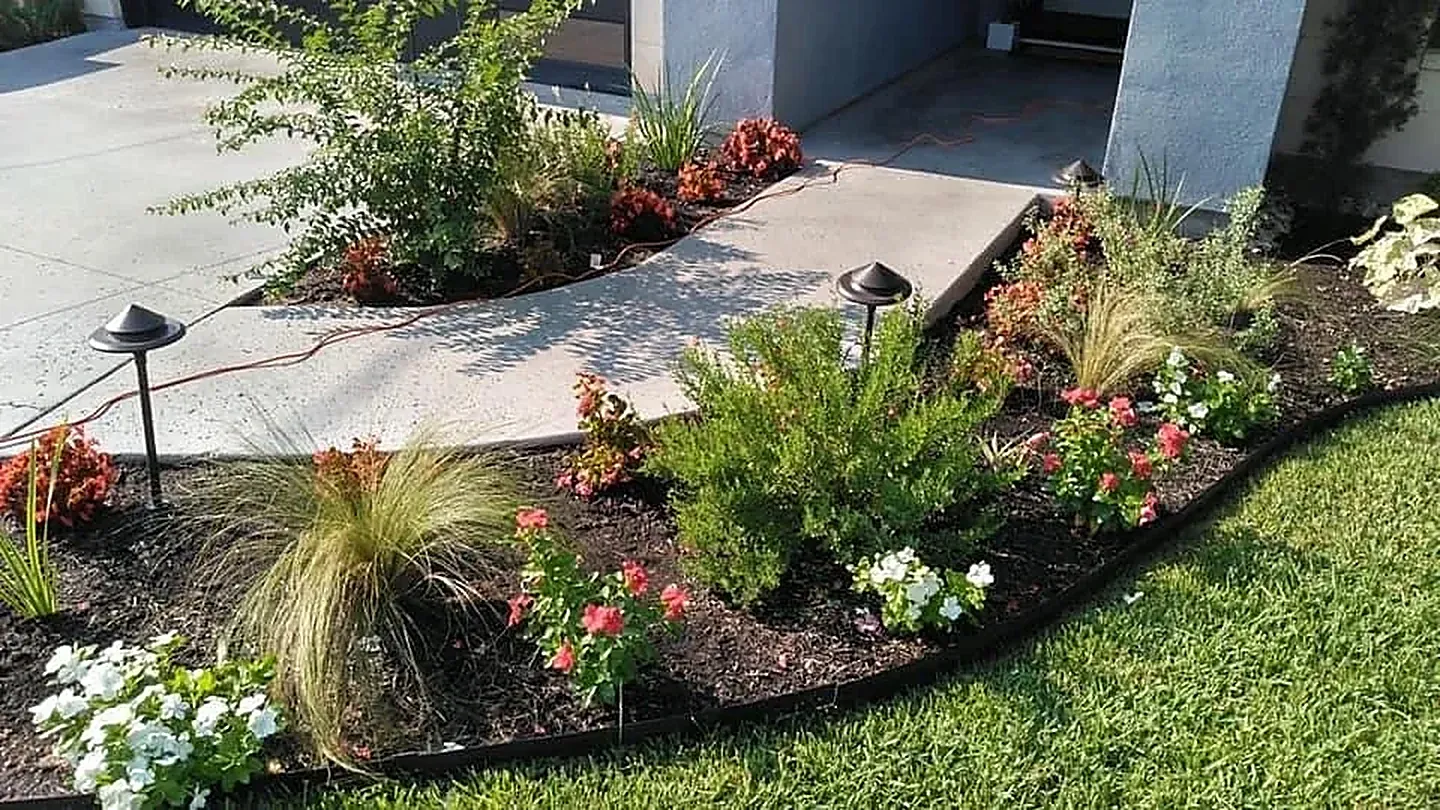 Front walkway flower bed cared for by LBJ Gardens at a residential property in Kingsland, Texas near Lake LBJ