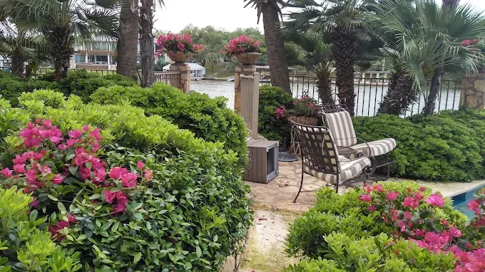 Lakeside shrub garden cared for by LBJ Gardens at a residential property in Kingsland, Texas near Lake LBJ