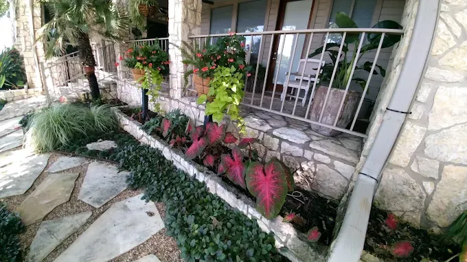 Porch garden maintenance cared for by LBJ Gardens at a residential property in Kingsland, Texas near Lake LBJ
