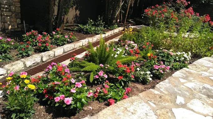 Raised flower bed cared for by LBJ Gardens at a residential property in Kingsland, Texas near Lake LBJ