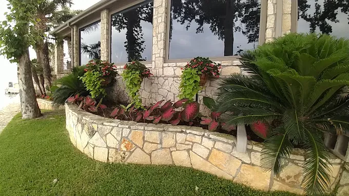 Stone planter garden cared for by LBJ Gardens at a residential property in Kingsland, Texas near Lake LBJ